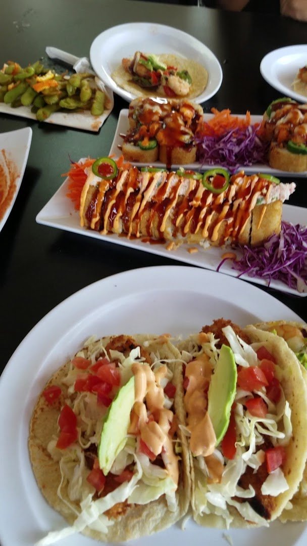 Colorful plates of Mexican seafood and sushi.